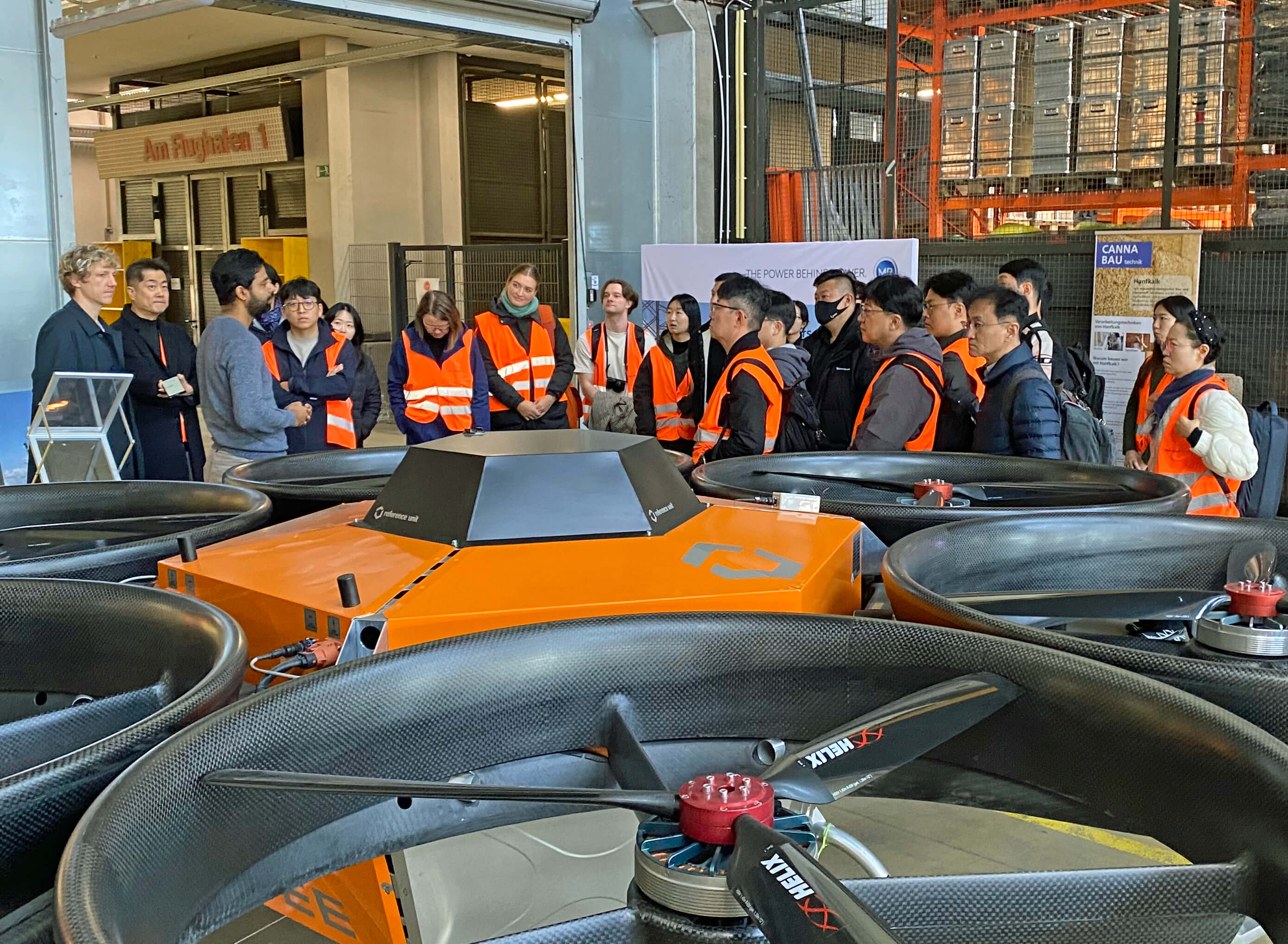 A picture of drones and the visiting group of Korean startups